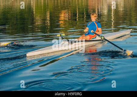 Caucasian man rowing on river Stock Photo