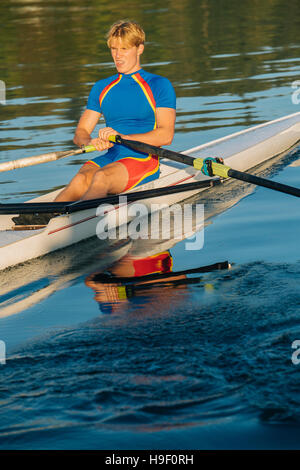 Caucasian man rowing on river Stock Photo