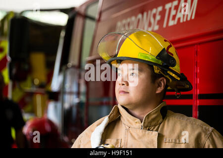 Chinese fireman standing near fire truck Stock Photo