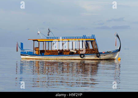 Side view of a sunlit Dhoni, traditional dive boat in Bathala, Maldives Stock Photo