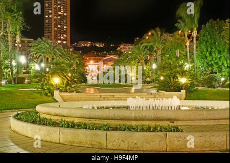 The evening walk in French style gardens of Monte Carlo, located opposite the Casino Square, Monaco. Stock Photo