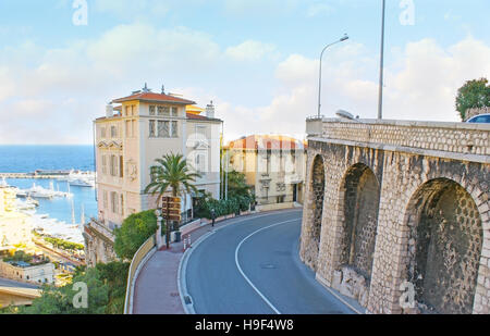 The winding Boulevard of Rainier III in La Condamine ward opens the view on the coastline with Port Hercules, full of yachts and boats, Monaco. Stock Photo