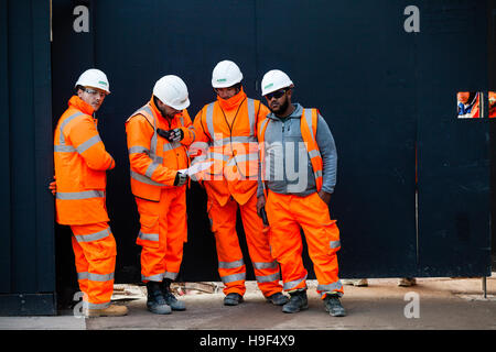 Groundsmen construction site workers in high visibility jackets on a building site, london Stock Photo