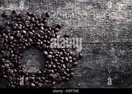 Assorted roasted coffee beans on a rustic, weathered textured driftwood background and empty space, overhead view with copyspace. Close up coffee bean Stock Photo