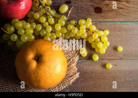 Pears and grapes on a wooden table. Stock Photo