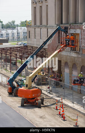 Two Cherry-Pickers and construction crews at work in Omaha, Nebraska, USA. Stock Photo