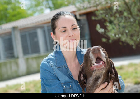 shelter keeper loves her residents Stock Photo