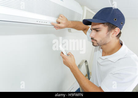 technician checking ac installation in clients building Stock Photo