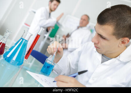 professionals pipetting master mix solution using multi channel pipette Stock Photo