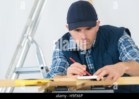 man drawing and modifying a house design Stock Photo