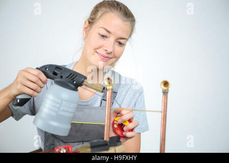 female welder in a metal shop Stock Photo