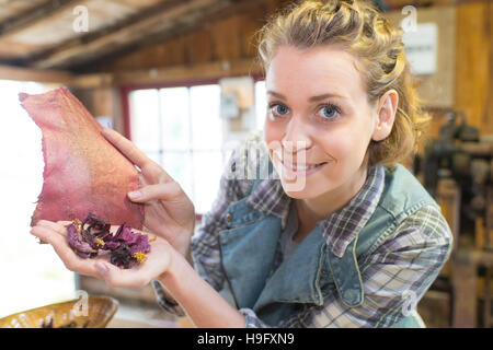 woman holding dry flowers in workshop Stock Photo