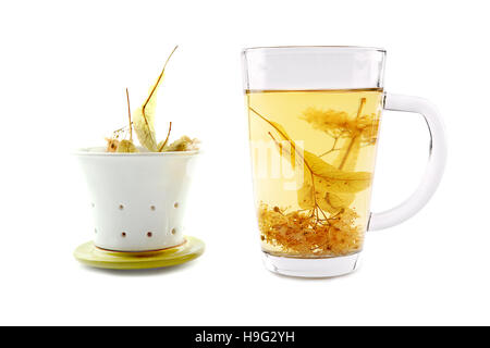 Lime tea cup with dried blossom. Glass cup of tea with herbal linden isolated on white Stock Photo