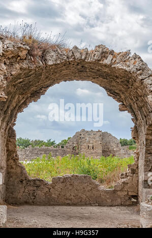 Part of the ancient city wall ruins that surround the town of Side in Turkey as seen from the nearby ancient hospital ruins. Stock Photo