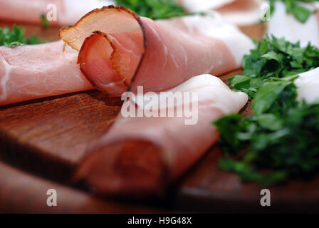 raw ham on wooden board Stock Photo