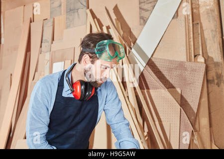 Artisan working at carpentry workshop cutting wood Stock Photo
