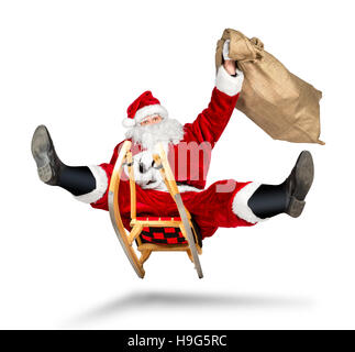 crazy santa claus on his sleigh hilarious fast funny crazy xmas christmas gift present delivery isolated white background Stock Photo