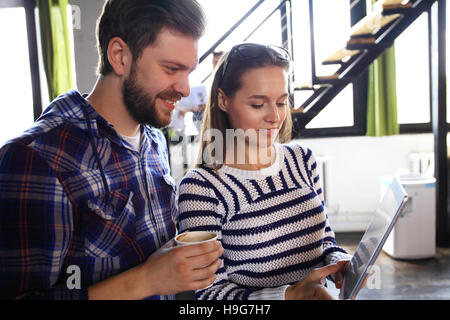 Team account manager project work.Photo business managers working with new startup in modern loft.Analyze reports,plans. Notebook on wood table, papers, documents, statistics. Stock Photo