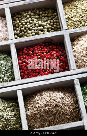 Spices in a case, pink pepper, peppercorns, cumin Stock Photo