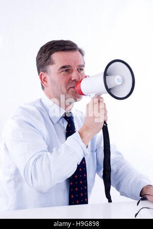Businessman, 50+, using a megaphone Stock Photo