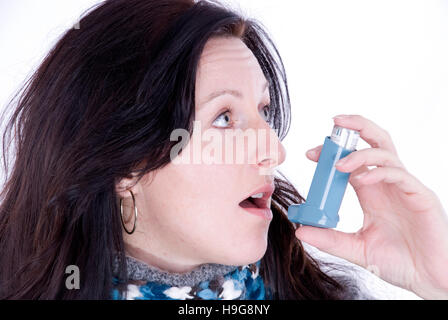 Woman using an asthma inhaler Stock Photo