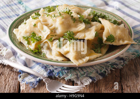 Swabian cuisine: Maultaschen dumplings stuffed with meat and spinach on a plate close-up. horizontal Stock Photo