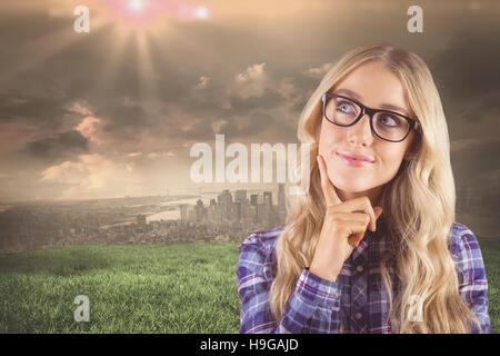 Composite image of gorgeous smiling blonde hipster daydreaming Stock Photo