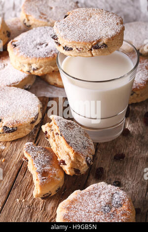 Traditional Welsh cakes with raisins and milk on the table close-up. vertical Stock Photo