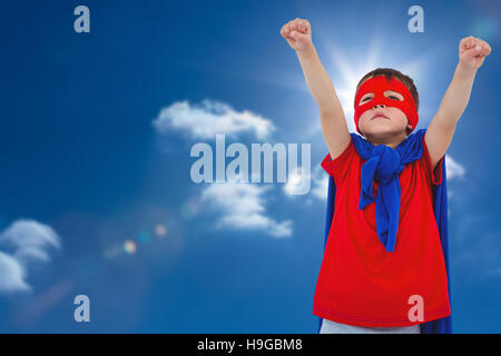Composite image of masked boy pretending to be superhero Stock Photo