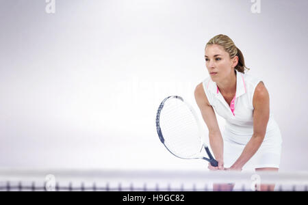 Composite image of athlete playing tennis with a racket Stock Photo