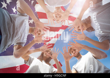Composite image of friends putting their hands together Stock Photo