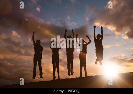 Composite image of children jumping at park Stock Photo