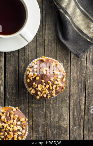 Sweet hazelnut muffins on old wooden table. Top view. Stock Photo