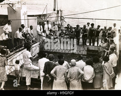 Antique c1930 photograph, passengers aboard the SS Virginia look in the swimming pool tank. SS Brazil was a US turbo-electric ocean liner. She was completed in 1928 as SS Virginia, and refitted and renamed as SS Brazil in 1938. SOURCE: ORIGINAL PHOTOGRAPHIC PRINT. Stock Photo