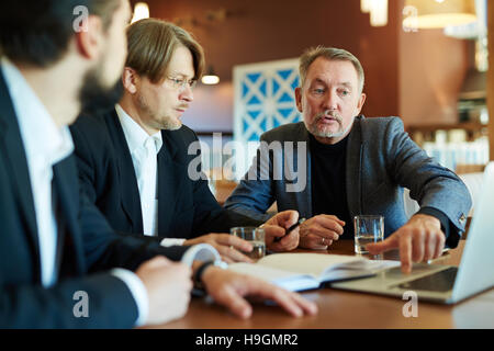 Confident leader making presentation of new ideas to employees Stock Photo