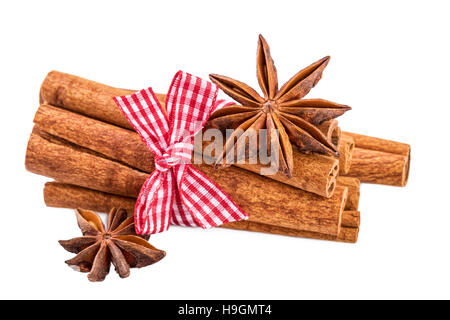 Cinnamon sticks bundle and anise over white.Traditional Christmas spices isolated on white. Stock Photo
