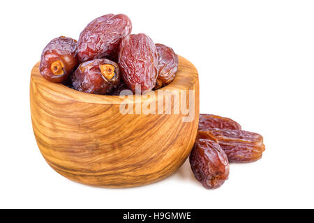 sweet dates in olive wood cup on white Stock Photo