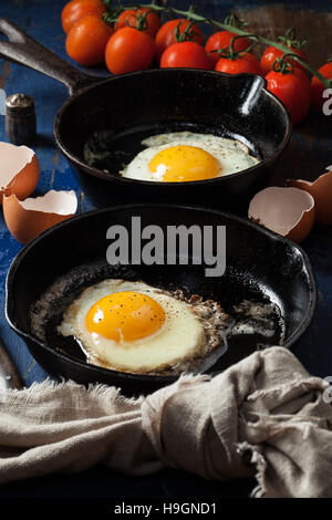 Fried eggs in a cast iron skillet Stock Photo