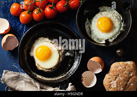 Fried eggs in a cast iron skillet Stock Photo