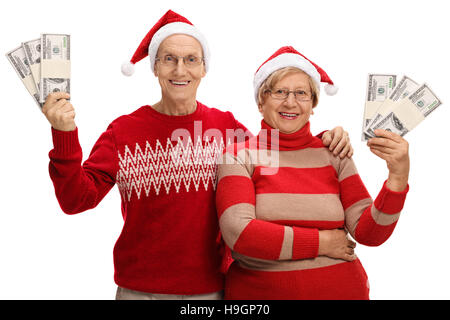 Happy seniors with christmas hats and money bundles isolated on white background Stock Photo