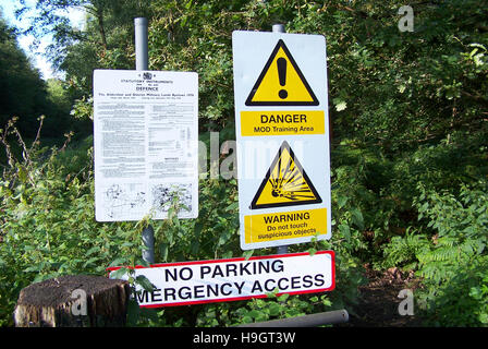 Danger warning signs at a Ministry of Defence training area, warning the public about unexploded bombs. Stock Photo