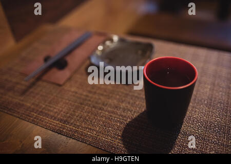 Cup of sake on dining table Stock Photo