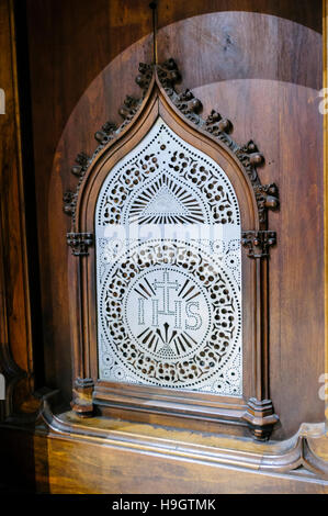 Metal screen at the confessional box in a Catholic church. Stock Photo