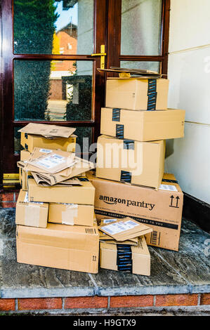 Amazon, Amazon Prime, and Amazon Pantry boxes on the front step of a house after being delivered. Stock Photo