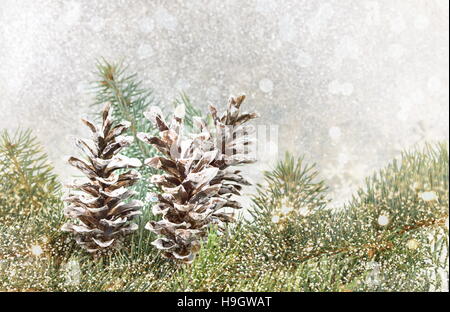 Pinecones and fir tree on sparkling background. Christmas decoration background Stock Photo