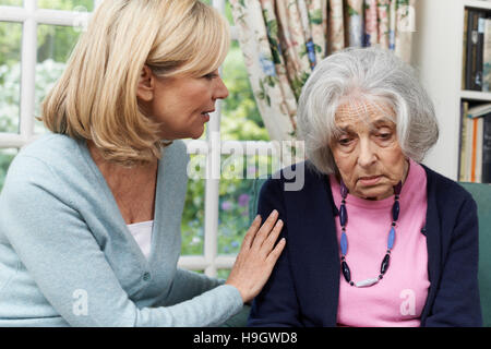 Mature Female Friend Comforting Unhappy Senior Woman Stock Photo