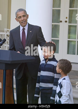 Washington DC, USA. 23rd November, 2016. United States President Barack Obama, left, joined by nephews Austin Robinson, 6, center, and Aaron Robinson, 4, right, pardons the 2016 National Thanksgiving Turkey, Tater, and its alternate Tot, during a ceremony in the Rose Garden of the White House in Washington, DC. This is the 69th anniversary of this honored tradition began in 1947 by President Harry S Truman. Credit:  MediaPunch Inc/Alamy Live News Stock Photo