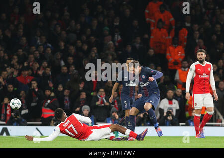 Emirates Stadium, London, UK. 23rd Nov 2016. Alex Iwobi of Arsenal (17) tackles Grzegorz Krychowiak of Paris Saint-Germain during the UEFA Champions League match between Arsenal and Paris Saint-Germain at the Emirates Stadium in London. November 23, 2016. Credit:  Telephoto Images / Alamy Live News Stock Photo