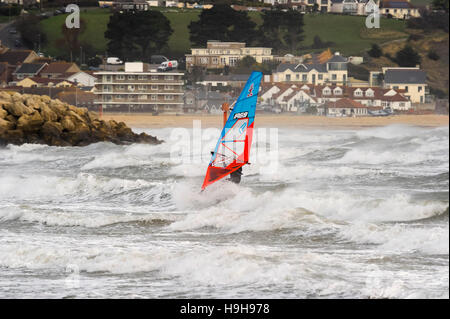 Weymouth, Dorset, UK.  24th November 2016.  UK Weather.  A view towards Overcombe across a sea of white horses on the waves ar whipped up by strong winds and choppy seas at Weymouth Beach in Dorset which a windsurfer is taking full advantage of.  Photo by Graham Hunt/Alamy Live News Stock Photo