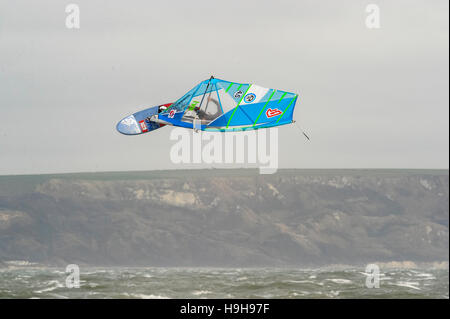 Weymouth, Dorset, UK.  24th November 2016.  UK Weather.  A windsurfer taking advantage of the strong winds and choppy seas off Weymouth Beach in Dorset to do a somersault in the air.  Photo by Graham Hunt/Alamy Live News Stock Photo